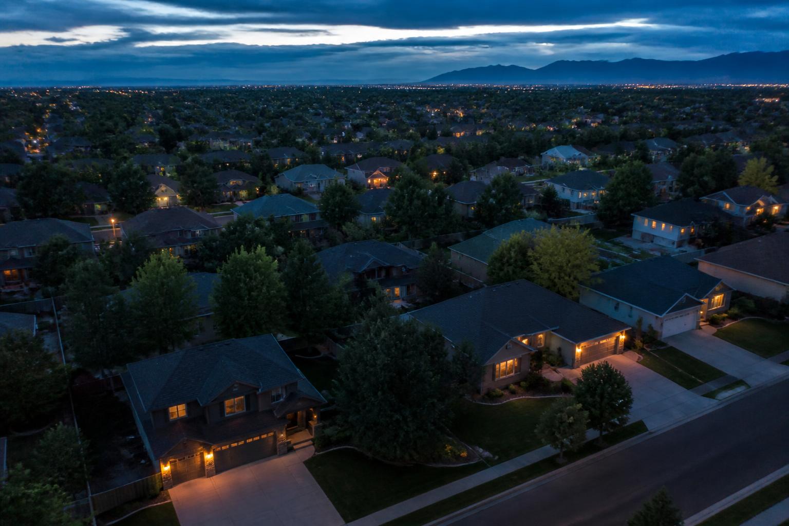 Aerial view of a suburban neighborhood of homes at dusk